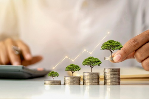 A,Businessman,Holding,A,Coin,With,A,Tree,That,Grows