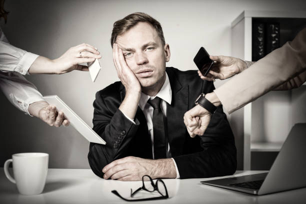Exhausted office worker having to many tasks and responsibilities at work